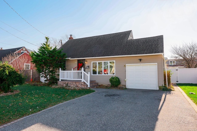 view of front of house featuring a garage and a front yard