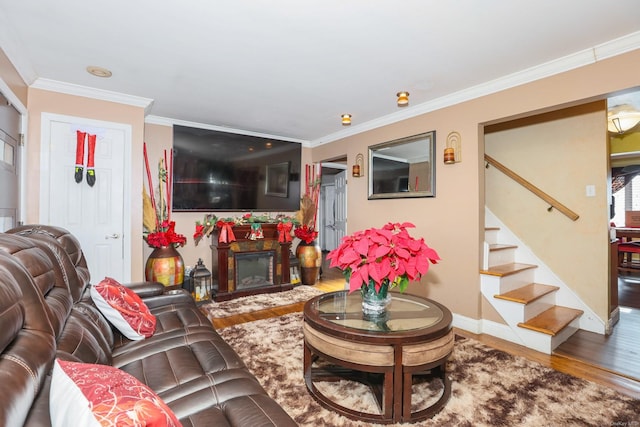 living room with hardwood / wood-style flooring and ornamental molding