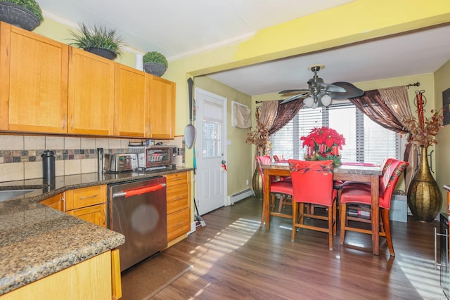 kitchen featuring dishwasher, dark wood-type flooring, a baseboard heating unit, ceiling fan, and decorative backsplash