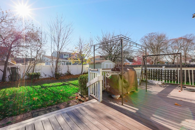 wooden deck featuring a storage unit