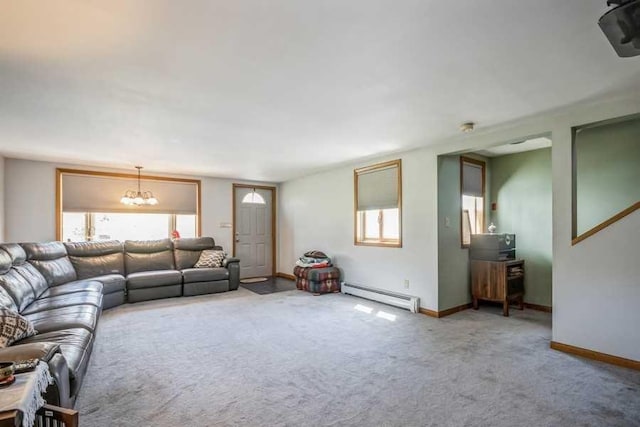 carpeted living room with a wealth of natural light, a baseboard radiator, and an inviting chandelier