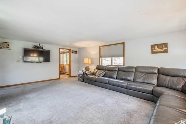 carpeted living room featuring baseboard heating