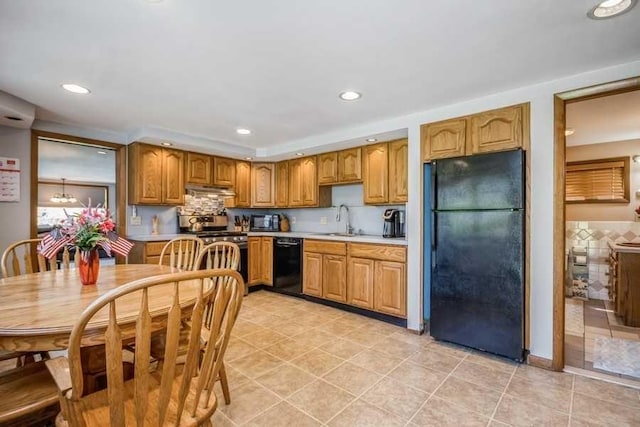 kitchen featuring black appliances, light tile patterned floors, sink, and tasteful backsplash