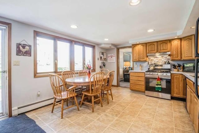 kitchen with backsplash, a baseboard heating unit, dishwasher, stainless steel stove, and light tile patterned flooring