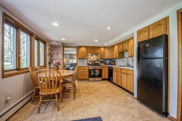 kitchen with a baseboard heating unit, black appliances, sink, decorative backsplash, and light tile patterned floors