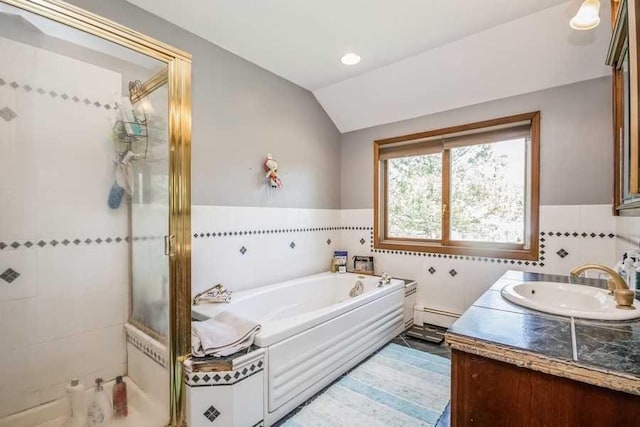 bathroom featuring vanity, independent shower and bath, lofted ceiling, and a baseboard radiator