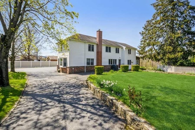 rear view of property with a yard