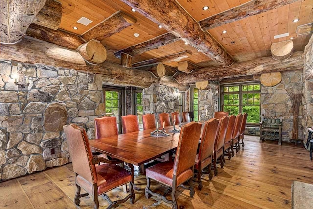 dining space featuring beamed ceiling, light wood-type flooring, and wood ceiling