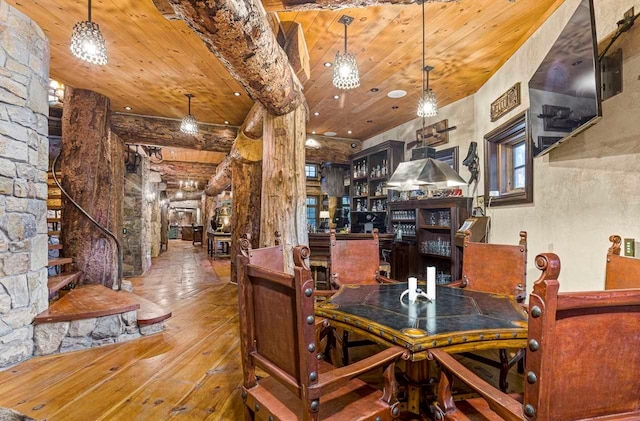 dining area featuring wood-type flooring and wooden ceiling