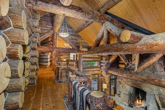 interior space with rustic walls, wooden ceiling, beamed ceiling, and wood-type flooring