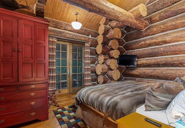 bedroom with wood ceiling, rustic walls, and wood-type flooring