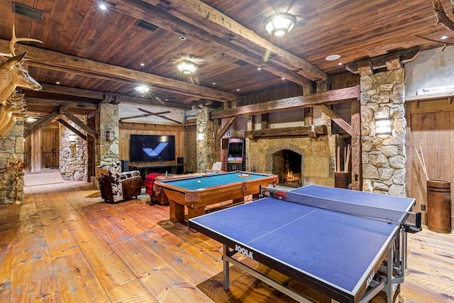 playroom featuring light hardwood / wood-style flooring, a stone fireplace, decorative columns, and billiards