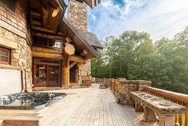 wooden terrace with an outdoor hot tub