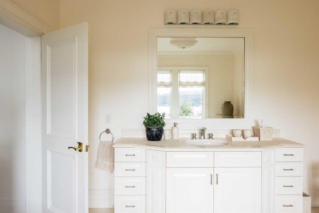 bathroom featuring vanity and ornamental molding