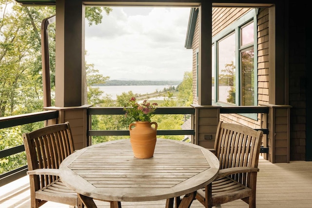 sunroom / solarium with a water view