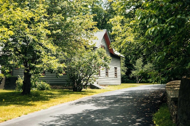 view of side of home with a lawn