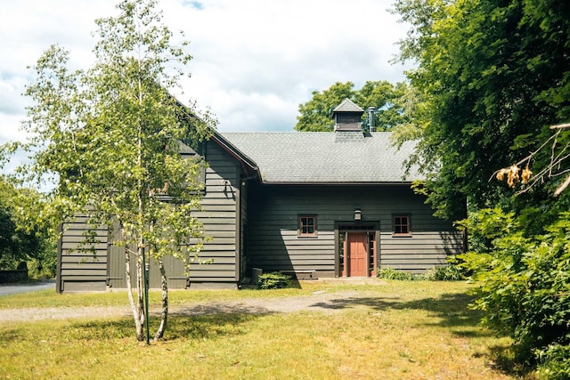 rear view of house with a yard