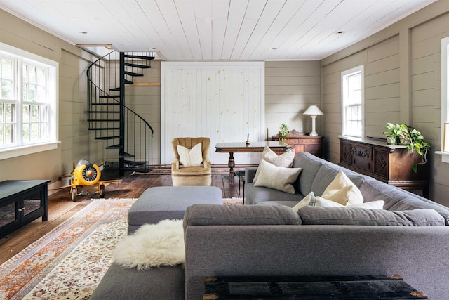 living room with wood ceiling, wooden walls, a healthy amount of sunlight, and hardwood / wood-style flooring