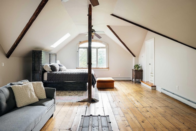 bedroom featuring ceiling fan, light wood-type flooring, a baseboard radiator, and lofted ceiling with skylight