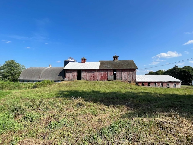 rear view of house with a yard