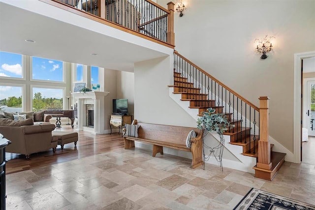 staircase featuring light tile floors and a high ceiling