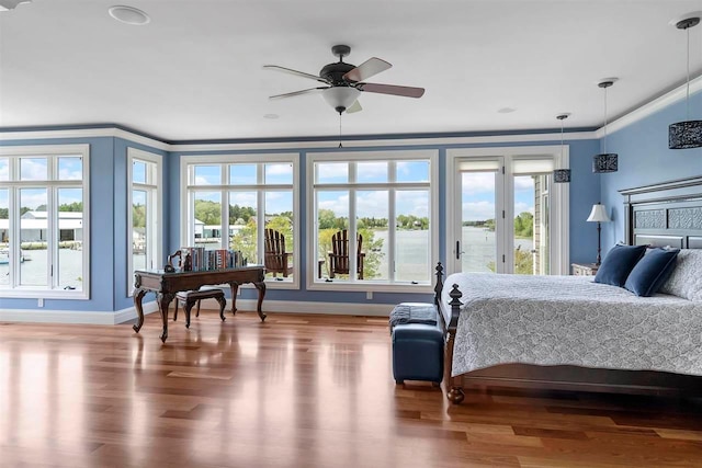 bedroom featuring ceiling fan, light wood-type flooring, and ornamental molding