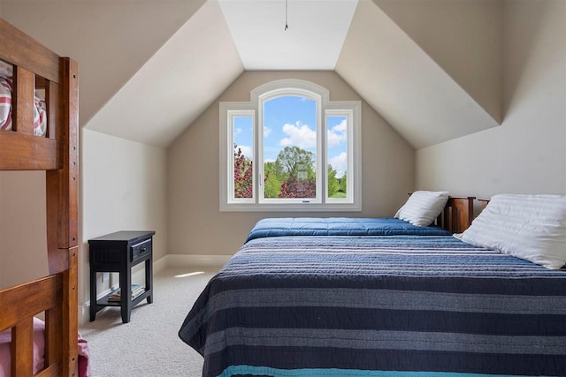 carpeted bedroom featuring lofted ceiling