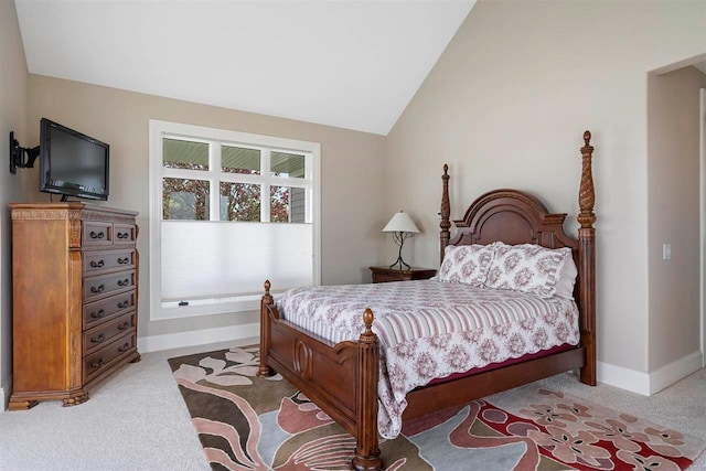 bedroom featuring lofted ceiling and light carpet