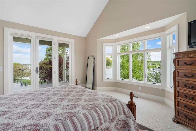 bedroom featuring light colored carpet, access to exterior, and high vaulted ceiling