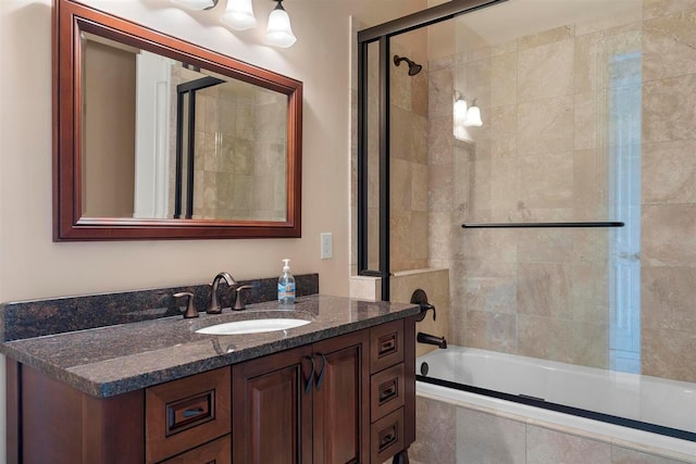 bathroom with combined bath / shower with glass door and vanity with extensive cabinet space