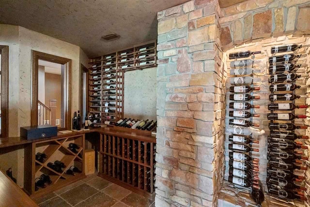 wine cellar featuring dark tile floors