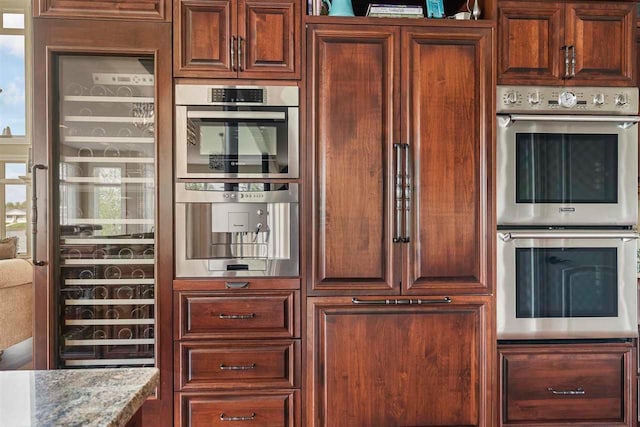 kitchen with double oven and light stone countertops