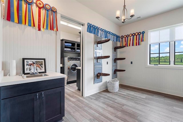 interior space with wood finished floors, baseboards, visible vents, and washer / dryer