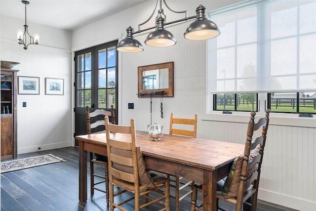 dining space with a chandelier, dark wood-style floors, baseboards, and radiator