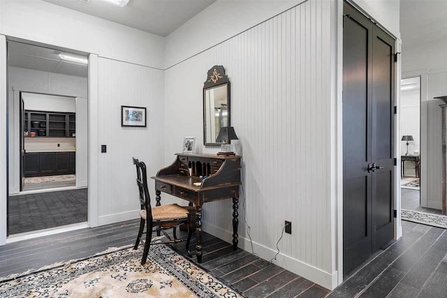 home office featuring baseboards and dark wood-style floors