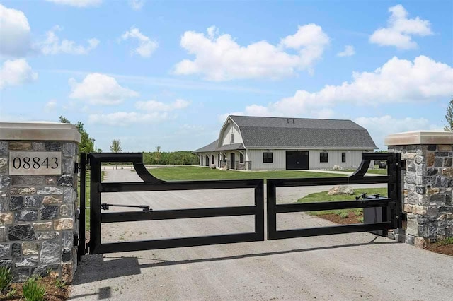 view of gate featuring a yard and fence