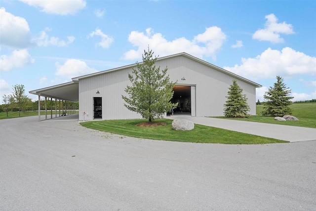 view of front of property with an outbuilding, a front lawn, an outdoor structure, and a garage
