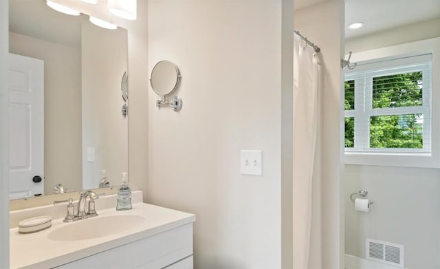 bathroom with vanity and visible vents