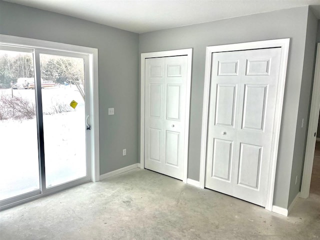 unfurnished bedroom with two closets