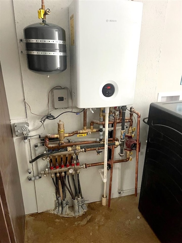 utility room featuring tankless water heater