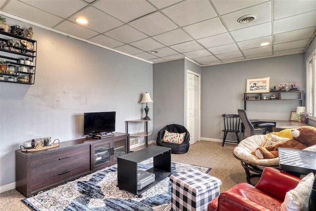 living room featuring carpet and a paneled ceiling