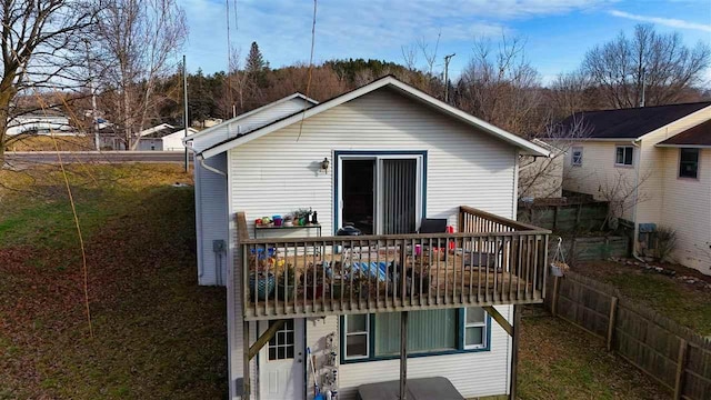 rear view of house featuring a wooden deck