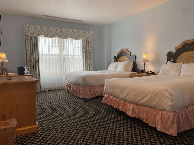 bedroom featuring dark carpet