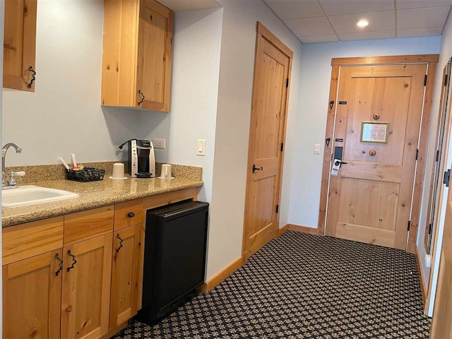 kitchen featuring sink and light stone counters