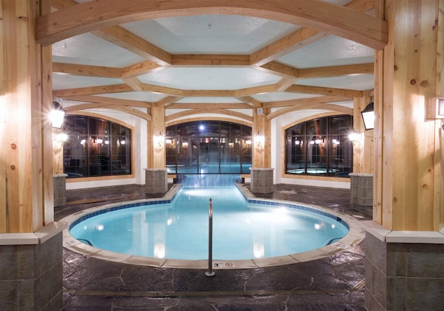 view of swimming pool with a hot tub