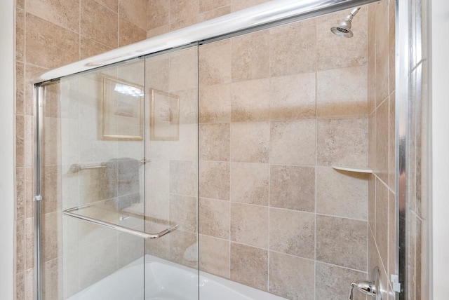 bathroom with shower / bath combination with glass door