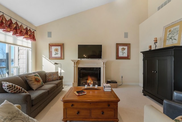 living room with light carpet and high vaulted ceiling