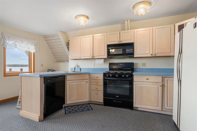 kitchen with dark colored carpet, black appliances, kitchen peninsula, and sink