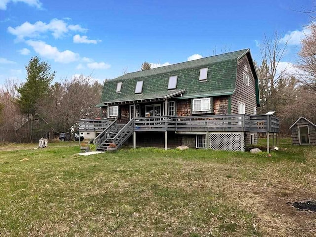 back of house with a deck and a lawn