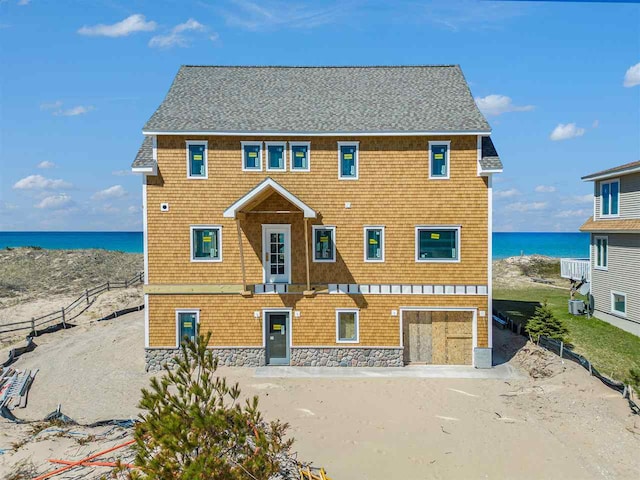 view of front of home featuring a water view and central AC